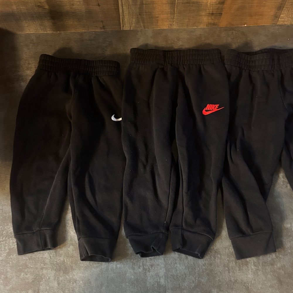 Nike Kids Black Joggers with Red Logo